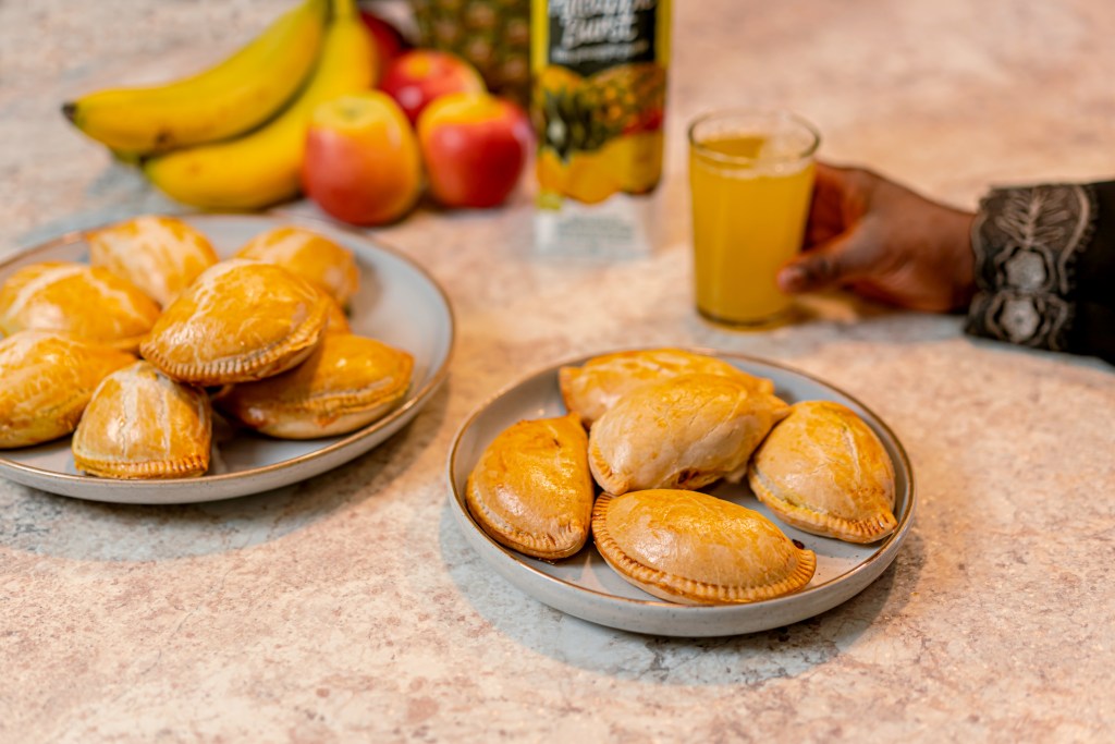 Served Nigerian meat pie with juice on dining table – Gees Pastries